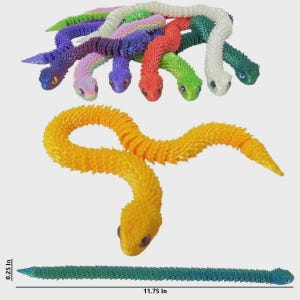 May include: A collection of articulated, segmented toy snakes in various colors including yellow, orange, red, green, purple, and white. Each snake features a textured, scale-like surface and distinct eyes. A ruler indicates a length of 11.75 inches.