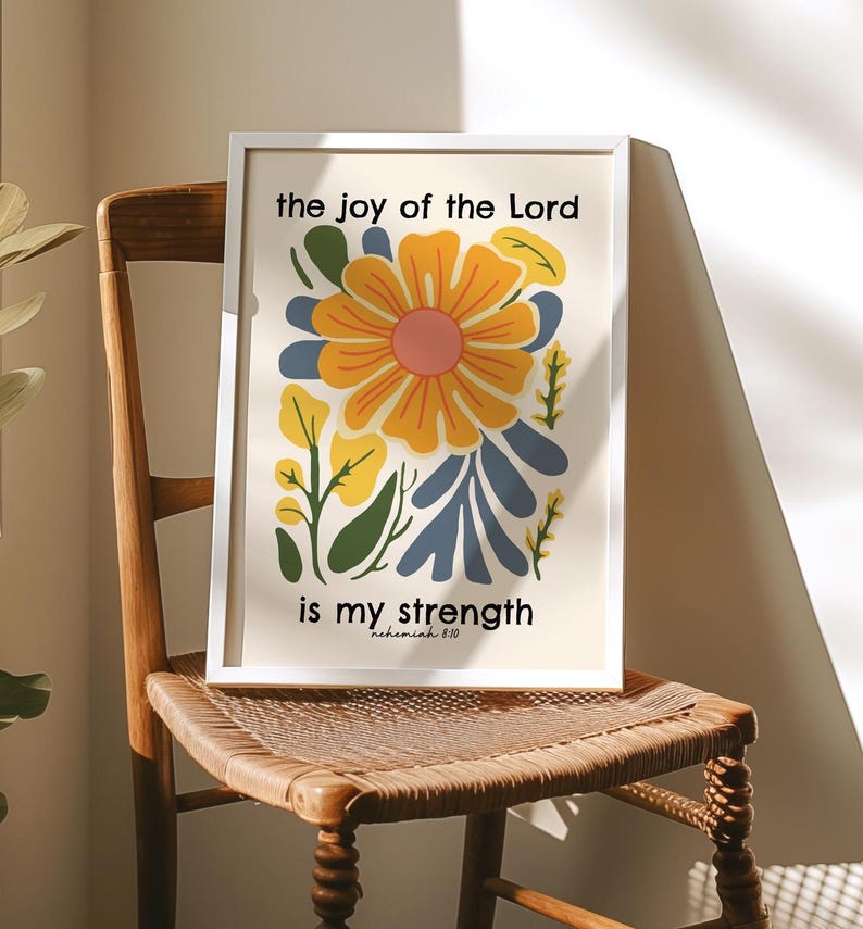 May include: A white framed print with a floral design and the text "the joy of the Lord is my strength - Nehemiah 8:10".
