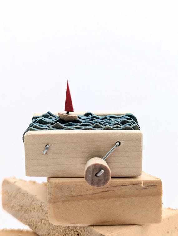 A wooden sailboat automaton with 1,435 hearts — waves rock, sails tilt, and the whole thing runs on pure mechanical ingenuity.