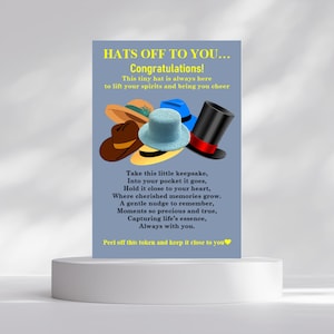May include: A greeting card with the text "HATS OFF TO YOU... Congratulations!" and a collection of miniature hats in various colors. The card includes a poem and a message to peel off a token.