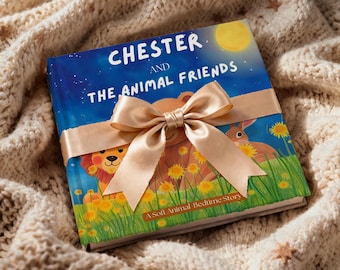 May include: A children's book titled "Chester and The Animal Friends" with a gold ribbon tied around it. The book cover features illustrations of a lion, bear, and rabbit in a field of yellow flowers under a night sky.