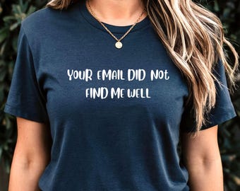 May include: A navy blue t-shirt with the text "Your email did not find me well" printed in white.