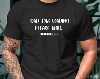 May include: Black t-shirt with the text "DAD JOKE LOADING PLEASE WAIT..." in white, along with a loading bar graphic. The shirt is a crew neck style.
