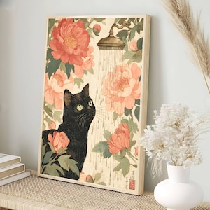 May include: A framed art print featuring a black cat looking up at a showerhead with water droplets. The background is filled with large, pink and red peonies and green leaves. The artwork has a vintage, Japanese-inspired aesthetic.