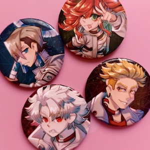 May include: Four circular pin badges featuring anime-style character illustrations. The badges depict different characters with various hair colours and expressions, set against dark and patterned backgrounds. The badges are on a pink background.
