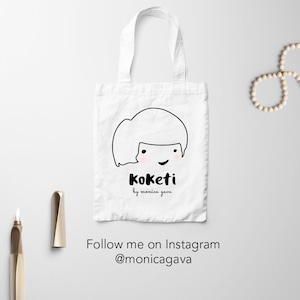 May include: White tote bag with a black line drawing of a person with short hair and the text "Koket by monica gava". The text "Follow me on Instagram @monicagava" is below the bag.