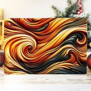 May include: Rectangular decorative cutting board with a swirling abstract design in shades of gold, orange, and dark gray. The pattern resembles flowing waves or wood grain. The board is set against a blurred background.