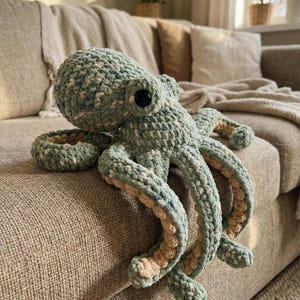 May include: A set of three ceramic mugs with a speckled, matte finish. The mugs are in shades of cream, light grey, and dark grey. Each mug has a simple, minimalist design, ideal for coffee or tea.