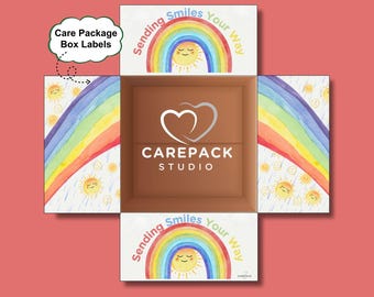 May include: An open cardboard box with a brown interior and a red exterior. The box's flaps display a rainbow and sun design with the text "Sending Smiles Your Way." The Carepack Studio logo is visible inside the box. The words "Care Package Box Labels" are also visible.