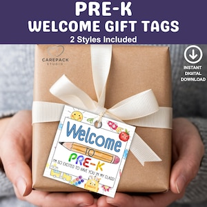 May include: A wrapped gift with a cream ribbon and a welcome tag for Pre-K students. The tag features colorful illustrations of a pencil, school bus, and smiling sun. Text on the tag reads "Welcome to Pre-K".