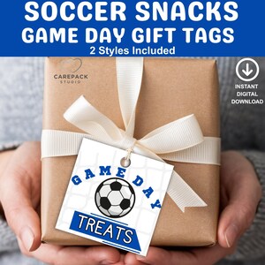 May include: A wrapped gift with a white ribbon and a tag that says "Game Day Treats" with a soccer ball graphic. The tag is blue and white. The text "Soccer Snacks Game Day Gift Tags" is at the top.