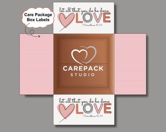 May include: An open care package box with pink striped sides and a brown interior. The box features the text "let all that you do be done LOVE 1 Corinthians 16:14" and the "CAREPACK STUDIO" logo. The box is designed for care package box labels.