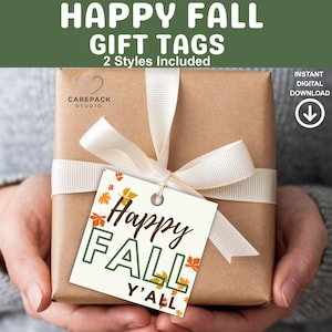 May include: A wrapped gift box with a cream-colored ribbon and a gift tag that reads "Happy Fall Y'all." The tag features fall leaves and the words "Happy Fall" in a decorative font. The words "Gift Tags" and "2 Styles Included" are at the top.