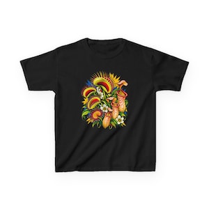 May include: A black short-sleeved t-shirt featuring a vibrant graphic print of various carnivorous plants, including Venus flytraps and pitcher plants in shades of red, yellow, and green, accented with small white flowers and green foliage.