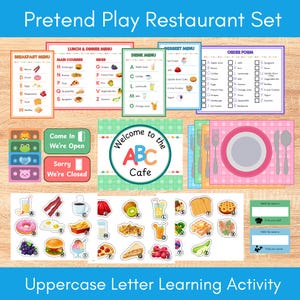 May include: A pretend play restaurant set with menus, order forms, and food cutouts. Includes breakfast, lunch, and dessert menus, plus a sign that says "Welcome to the ABC Cafe." The set is designed for uppercase letter learning.