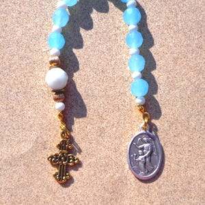 Guardian Angel, gold tone cross, blue-white beads