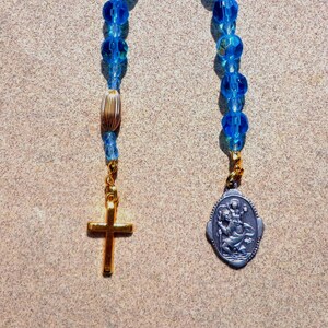 Saint Christopher, gold tone cross, blue glass beads, medal