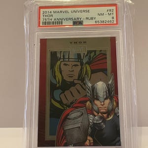 May include: A 2014 Marvel Universe Thor 75th Anniversary Ruby trading card, encased in a protective holder. The card features a comic book illustration of Thor, with the text "THOR" and "MARVEL". The card is graded NM-MT 8.