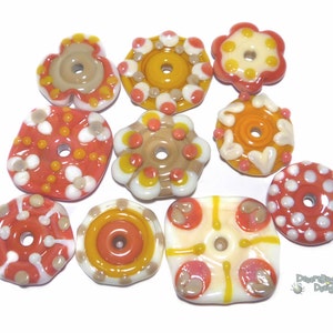 May include: Assortment of ten colorful glass beads with various patterns and designs. The beads are in shades of orange, yellow, white, and brown. Each bead has a hole in the center for stringing.