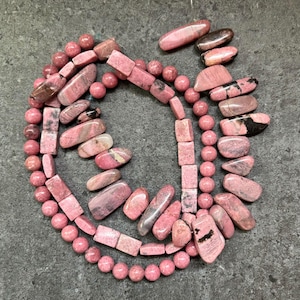 May include: A set of three ceramic mugs with a speckled, matte finish. The mugs are in shades of cream, light gray, and dark gray. Each mug has a simple, minimalist design, perfect for coffee or tea.