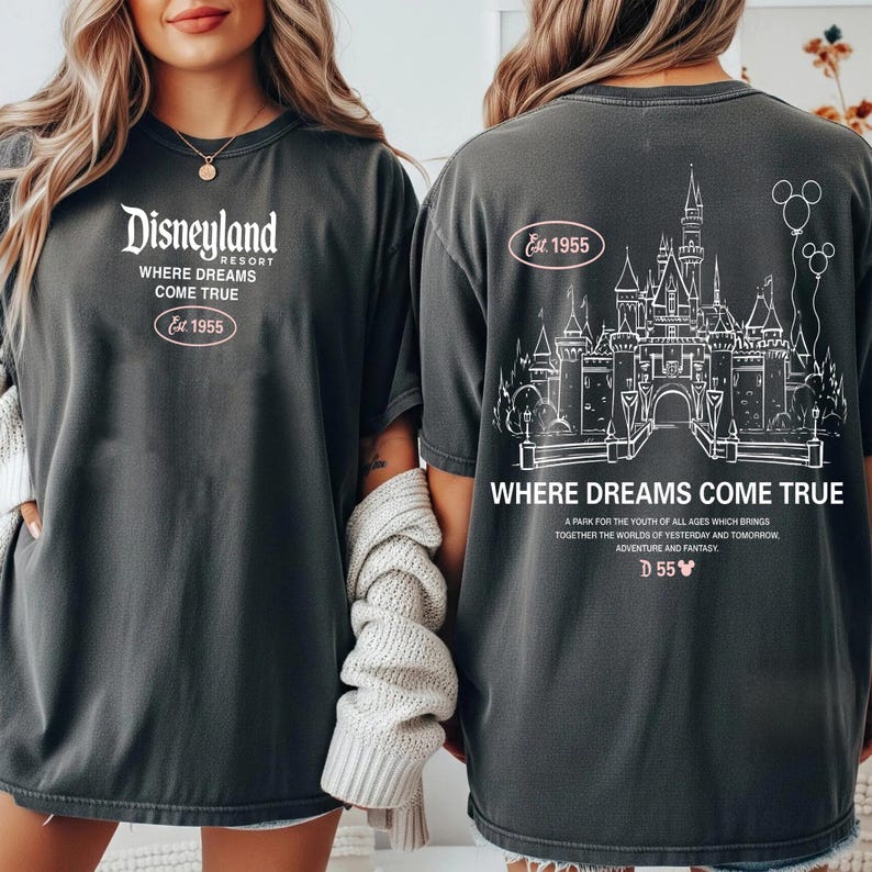 May include: Dark gray t-shirts with white text and graphics. The front of the shirt says "Disneyland Resort, Where Dreams Come True, Est. 1955." The back features a castle graphic and the words "Where Dreams Come True."