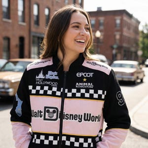 May include: Black and pink Walt Disney World racing jacket with white checkered accents. The jacket features logos for Magic Kingdom, Hollywood Studios, Epcot, and Animal Kingdom. The number 9 is on the sleeve.