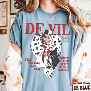 May include: A white ceramic mug with a black handle and the text "But First, Coffee" in a black, bold font. The mug is on a white surface.