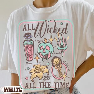 May include: White t-shirt with a colorful graphic design featuring the text "ALL Wicked ALL THE TIME." The design includes illustrations of a skull, a trident, and other themed elements.