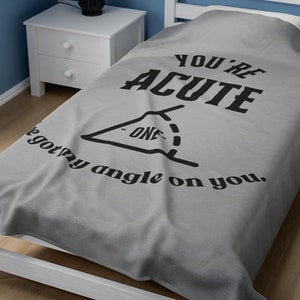 May include: A gray fleece blanket with the text "You're Acute" and a drawing of an acute angle with the text "I got my angle on you."
