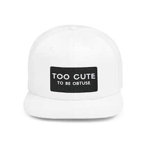 May include: A white baseball cap with a flat peak. The cap has a black rectangular patch on the front with the words "TOO CUTE TO BE OBTUSE" in white lettering. A casual, everyday style hat.