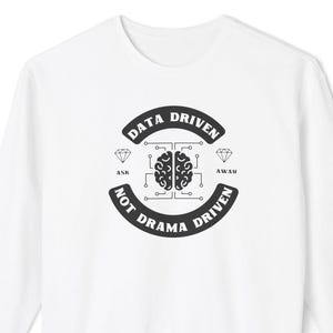 May include: White long-sleeve sweatshirt with a black graphic design. The design includes the text "DATA DRIVEN" and "NOT DRAMA DRIVEN" around a brain graphic. The sleeves have text that reads "DATA WHISPERER" and "ANALYZE IT ALL".
