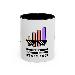 May include: White ceramic mug with a black rim. The mug features a graphic of a bar chart wearing sunglasses with the text "Let the data do the talking".
