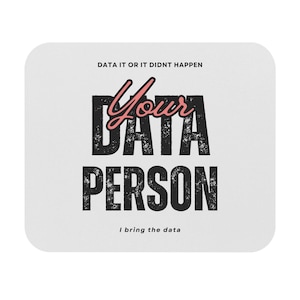 May include: A white mouse mat with black text that reads "Data it or it didn't happen. Your Data Person. I bring the data." The word "Your" is in pink.