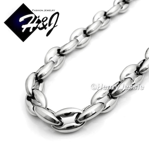 May include: A silver chain necklace with a thick, oval-shaped link design. The chain is made of stainless steel and is durable and stylish.