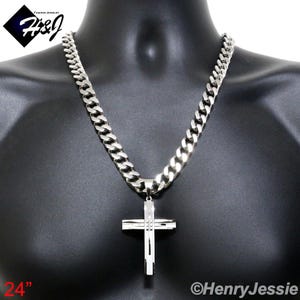 May include: A silver chain necklace with a large silver cross pendant. The chain is 24 inches long and has a curb link design. The cross pendant has a simple, modern design.