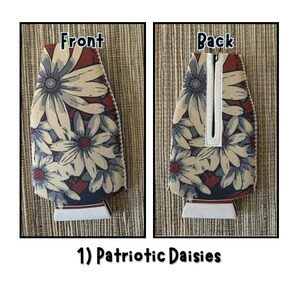 May include: Two views of a beverage insulator with a floral daisy pattern in cream, red, and blue. The front view is labeled "Front" and the back view is labeled "Back". The text "1) Patriotic Daisies" is at the bottom.