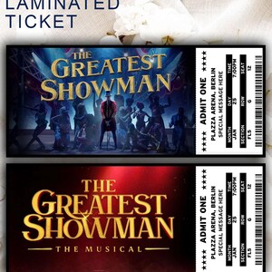 May include: Two laminated tickets for "The Greatest Showman" musical. The top ticket features a stage scene with the show's title in gold. The bottom ticket has the show's title in gold against a red background. Each ticket includes show details.