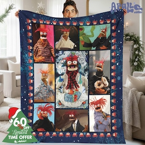 May include: A navy blue blanket featuring a collage of images of the Muppet character, Zoot. The blanket has a dark blue border with snowflake and character accents. A Christmas tree graphic with text that reads "60% OFF Limited TIME OFFER" is visible.