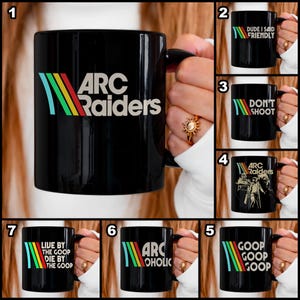 May include: Black ceramic mugs with various designs. One mug features "ARC Raiders" with a retro color scheme. Other mugs display phrases like "DUDE I SAID FRIENDLY", "DON'T SHOOT", "GOOP GOOP GOOP", and "LIVE BY THE GOOP DIE BY THE GOOP".
