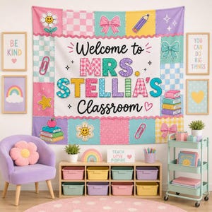 May include: A rectangular fabric wall hanging featuring a patchwork-style border with pastel colors and icons like flowers, bows, and pencils. The center white panel displays the text Welcome to MRS. STELLIA'S CLASSROOM in colorful letters.