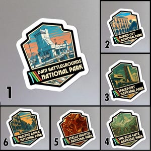 May include: Set of six stickers featuring stylized illustrations of national park scenes. Each sticker has a unique design and text, including "Dam Battlegrounds National Park" and "The Blue Gate National Park."