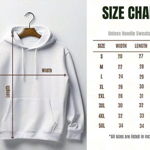 May include: A white unisex hoodie sweatshirt hanging on a wooden hanger. The image includes a size chart with measurements in inches for width, length, and sleeve length, ranging from size S to 5XL.