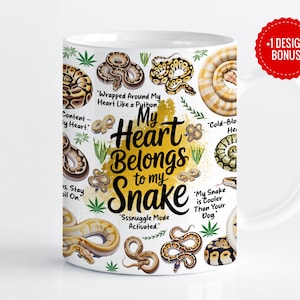 May include: White ceramic mug featuring various snake illustrations and the text "My Heart Belongs to my Snake." The mug includes phrases like "Wrapped Around My Heart Like a Python" and "Sssnuggle Mode Activated."