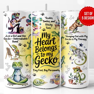 May include: Set of five gecko-themed tumblers with various designs. One tumbler features a gecko playing guitar, another has the text "My Heart Belongs to My Gecko," and others show geckos in different scenarios. The tumblers are decorated with colorful illustrations.