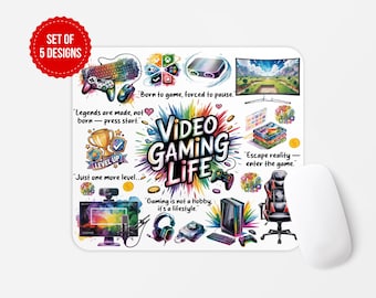 May include: A white rectangular mousepad with a colorful "Video Gaming Life" design. The design includes gaming-related illustrations, text, and a red circle that says "SET OF 5 DESIGNS". A white computer mouse is on the right.