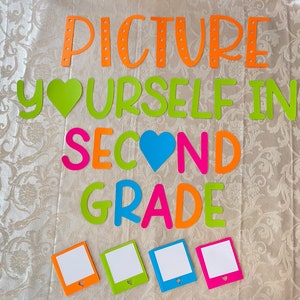 May include: A colorful sign that says "Picture Yourself in Second Grade" with a green heart and a blue heart. There are five blank photo frames with hearts in the bottom corners.
