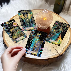 May include: Four tarot cards on a wooden surface with a crystal next to them. The cards are "The Chariot", "Judgment", "The Magician", and "The Emperor".