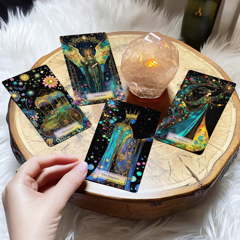 May include: Four tarot cards on a wooden surface with a crystal next to them. The cards are "The Chariot", "Judgment", "The Magician", and "The Emperor".