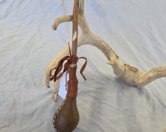 5" horse rawhide rattle - dented.