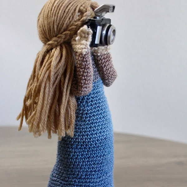 a crochet girl taking pictures